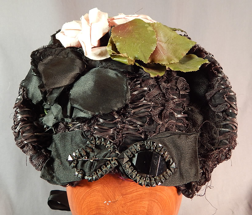 Victorian Woven Black Straw Pink Roses Jet Beaded Buckle Trim Bonnet Hat
The bonnet measures 8 by 7 inches, with a 5 inch wide inside crown. It is in good condition. This is truly a wonderful piece of wearable antique Victoriana millinery art!