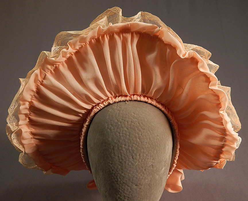 Victorian Style Ruth Stockley Society Silk Embroidery Floral Peach Bonnet Hat
It is made of a pastel peach color cotton fabric base with a vintage society silk floss embroidery linen fabric doily overlay covering the top which has a finely hand embroidered pastel Art Nouveau style floral leaf pattern design.