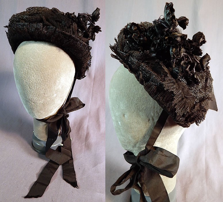 Victorian Black Woven Straw Lace Net Flowers Full Mourning Bonnet Hat
This antique Victorian era black woven straw lace, net, flowers full mourning bonnet hat dates from the 1880s. It is made of a small wired frame covered with black woven straw with ruched gathered layered on top, black tulle fishnet, lace ruffle trim, a black silk flower bouquet on the side and black silk grosgrain bow trim on the bottom back.