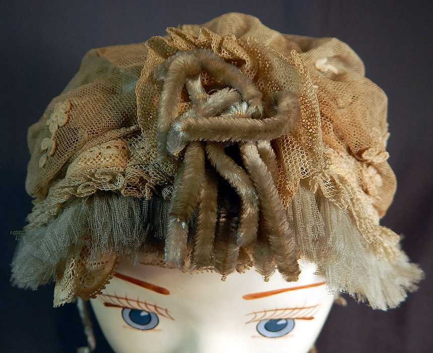 Victorian Cream Tulle Net Lace Blue Silk Chenille Trim Bed Cap Bonnet Hat
It is in good as-is condition with some fraying along the ruffle trim edging, inside silk lining and has some dingy dirty discoloration. This is truly a wonderful piece of home made millinery textile art! 