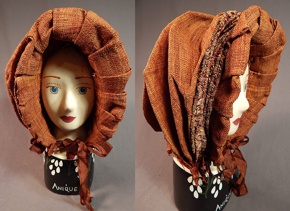 Victorian Woven Brown Straw Chintz Fabric Trim Calash Sun Bonnet Hood Hat
This antique Victorian era woven brown straw chintz fabric trim calash sunbonnet hood hat dates from the 1840s. It is made of a brown finely woven straw which resembles a more supple fabric, with pleated ruche tucks gathered support channels created from a colorful chintz calico print fabric trim. 