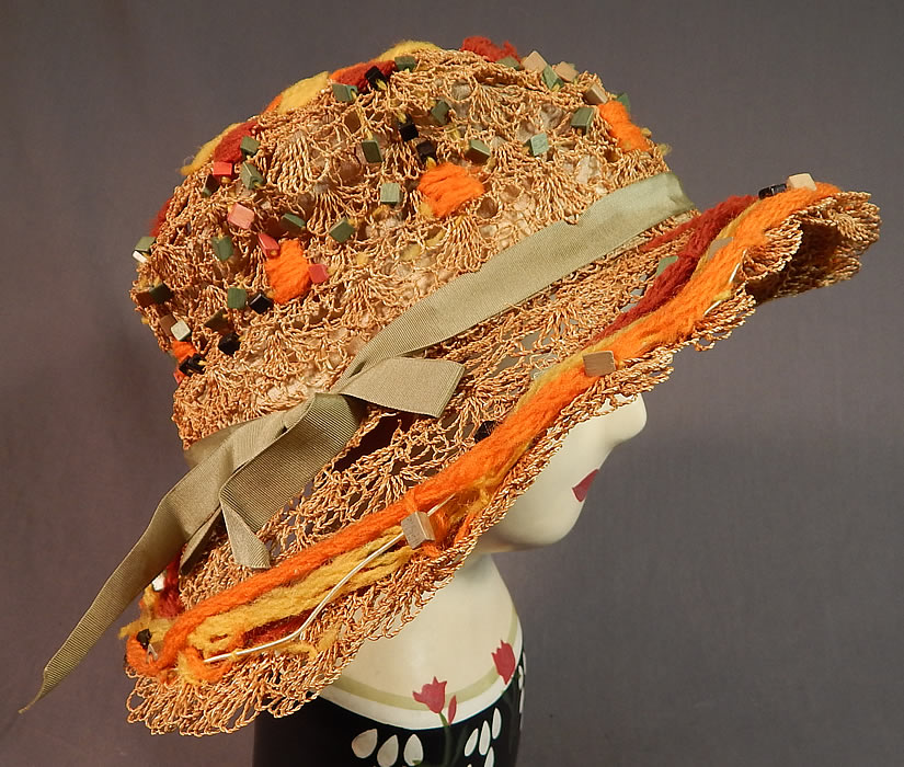Vintage Woven Natural Straw Colorful Wood Beaded Embroidered Yarn Wide Brim Cloche Hat
This sensational summer straw hat has a wired wide oval oblong shaped brim, a round crown with green grosgrain ribbon bow trim and is lined inside the crown with a cream color silk fabric. 