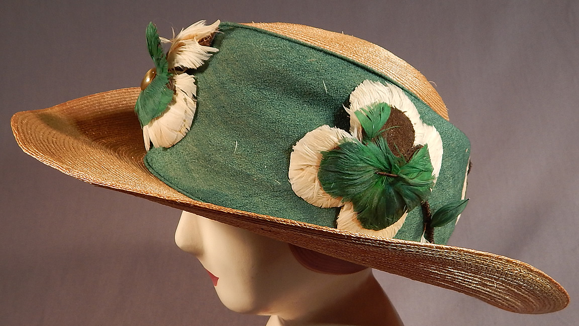 Vintage M. H. Loach Natural Woven Straw Green Ribbon Feather Rosette Wide Brim Hat
The hat is made of a woven natural straw with a green silk ribbon wide hatband trim, green and white feather rosette flower appliqu&eacute;d trim with gold metallic wrapped wire stems attached around the crown. 