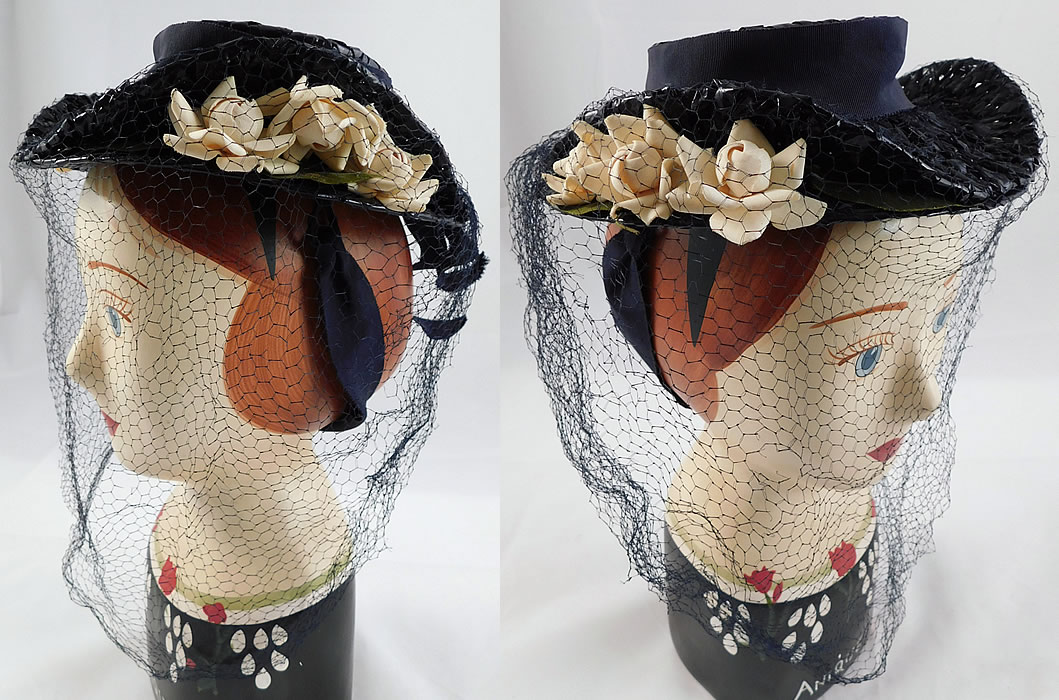 Vintage Taylor's Raleigh Flowering Dogwood Navy Blue Straw Veiled Fascinator Hat
This vintage Taylor's Raleigh flowering dogwood navy blue straw veiled fascinator hat dates from the 1940s. It is made of a navy blue woven straw with small white flowering dogwood flowers peeking out from in between the brim sides, a navy blue grosgrain ribbon hatband trim with bow back and blue sheer tulle net veil covering the front. 