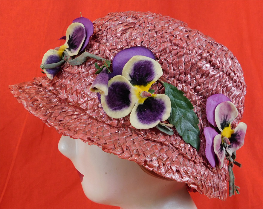 Vintage Woven Pink Straw Purple Velvet Pansy Flower Trim Cloche Hat Hatpin
This pretty pink cloche hat has a form fitting style, with matching pink straw tip hatpin on the side for securing onto the hair and is unlined. 