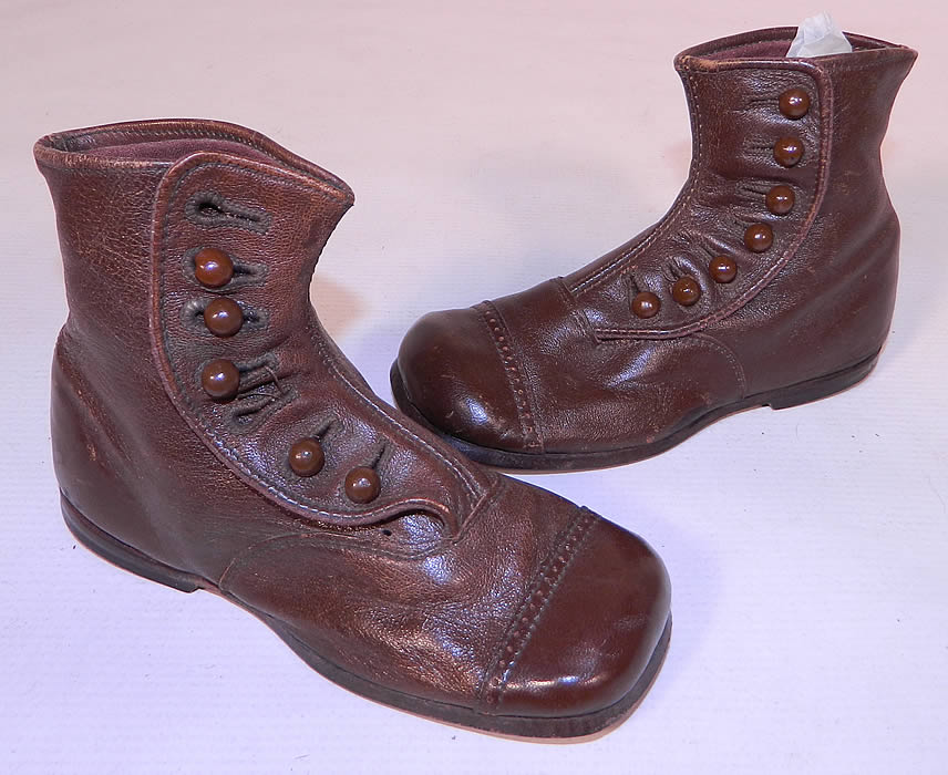 Victorian Antique Brown & Skylark Leather High Button Baby Boots Childs Shoes. This pair of antique Victorian era Brown & Skylark leather high button baby boots child's shoes date from 1900. They are made of a dark chocolate brown leather.