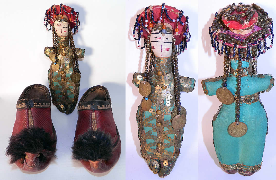 Vintage Greek Opanke Tsarouhi Childs Red Pompom Shoes & Folk Doll. The shoes measure 8 inches long and 3 inches wide. Included is a traditional folk costume dressed rag doll, hand made of cloth, with gold sequins, beading, decorative coins, a hand painted face and paper hat adorned with bead work. The doll measures 9 inches long. 