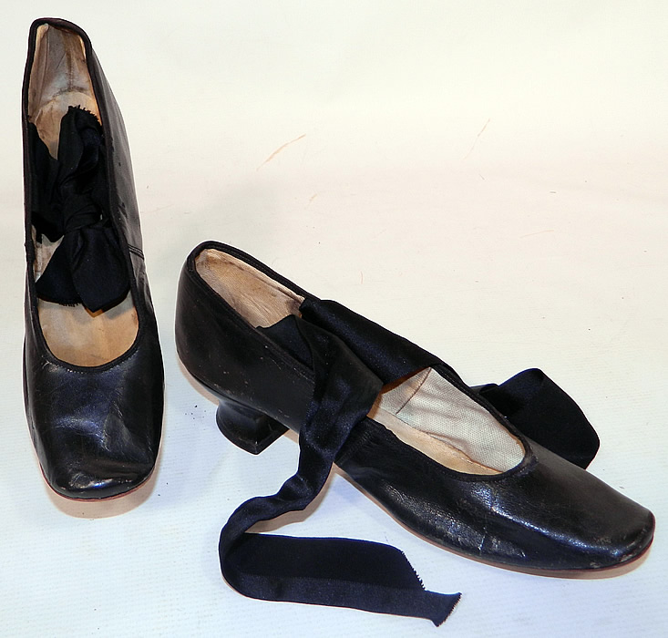 Victorian Kelly & Murphy Black Leather Ribbon Tie Shoes & Box. They are made of a black leather with black silk satin ribbon tie straps. These lovely ladies slipper style shoes have slightly squared toes, with ribbon tie straps across the instep, a black leather low French Louis XV heel and are lined with white kid leather and linen inside. 
