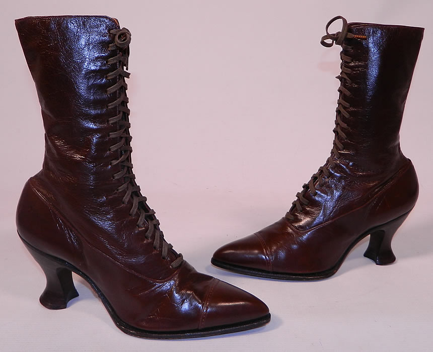 Unworn Victorian Walk Over Brown Leather High Top Lace-up Boots. This pair of antique Victorian era Walk Over brown leather high top lace-up boots date from 1900. They are made of a dark chocolate brown color leather, with decorative punch work designs across the toes.