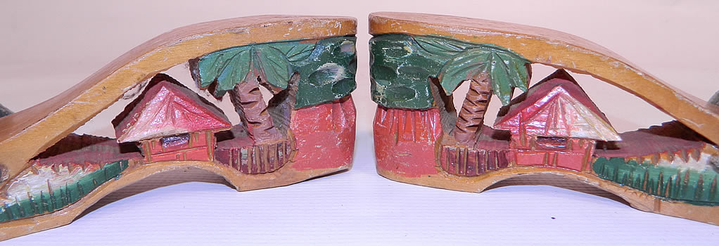 Vintage Philippines Hand Painted Carved Wooden Wedge Mules Sandal Shoes. Each &ldquo;souvenir shoe&rdquo; contained a miniature scene inside its wooden heel. The shoes measure 8 1/2 inches long, 2 1/2 inches wide and have a 2 1/2 inch high heel.