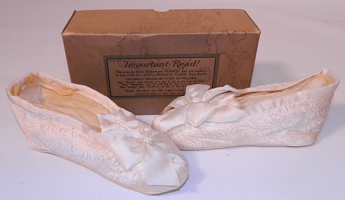 Vintage McCamish Funeral Burial Child's White Satin Slipper Shoes. This pair of vintage McCamish funeral burial child's white satin slipper shoes and box dates from the 1920s.