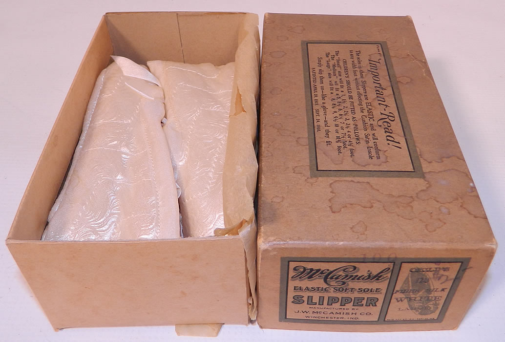 Vintage McCamish Funeral Burial Child's White Satin Slipper Shoes. They come in the original box from the "J.W. McCamish Company Winchester, IN" with a patent date of 1918 and are a stamped a Child's Size Large.