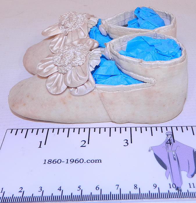 Victorian Antique White Velvet Rosette Maryjane Baby  Infant Shoes & Box. The shoes measure 4 1/2 inches long and 1 1/2 inches wide. They come in a pretty paper box covered with floral rose wallpaper along the sides and a beautiful litho print girl on the front, with an open top and side. 