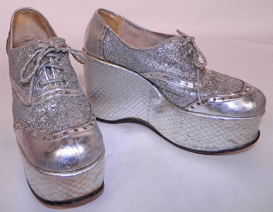Vintage Di Orsini Silver Glitter Snakeskin Disco Platform Shoes. This pair of vintage Di Orsini silver glitter snakeskin disco platform shoes dates from the 1970s. They are made of a silver metallic snakeskin reptile print leather and covered with silver glitter.