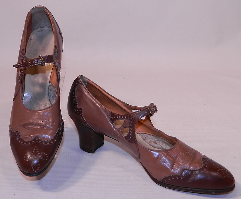 Vintage Two Tone Punchwork Brown Leather Buckle Strap Mary Jane Shoes. These women's Mary Janes style shoes have adjustable buckle straps across the instep vamps, with eyelet cutouts on the sides and wooden stacked cube heels. 