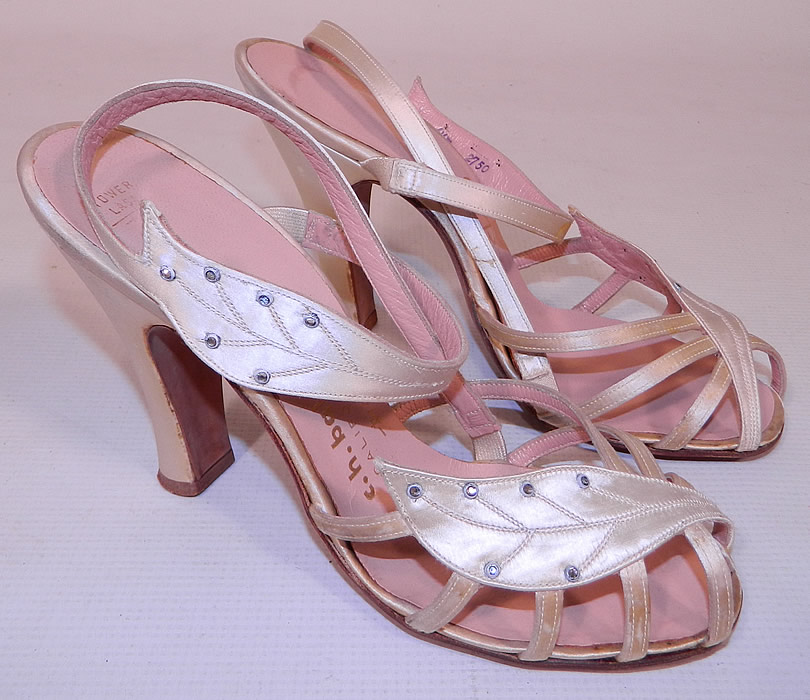 Vintage So Bel Creations by Fern White Satin Rhinestone Leaf Sling Back Sandal Shoes. This pair of vintage So Bel Creations by Fern white satin rhinestone leaf sling back sandal shoes date from the 1950s. They are made of a white satin fabric, with tiny silver studded rhinestones trimming the leaf shape straps. 