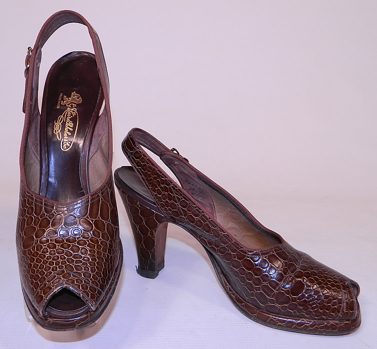 Vintage Laird Schober & Co Brown Leather Alligator Slingback Platform Shoes 
They are made of a brown leather, with a faux alligator print stamped pattern design. These sensational swing dance shoes pumps have a slip on style, with adjustable buckle slingback strap, peek-a-boo open toes, a slight platform lift front and modified boulevard heels. 