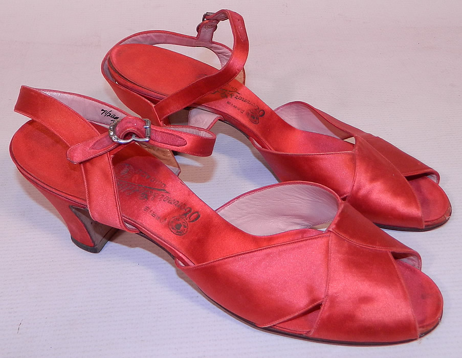 Vintage O'Connor & Goldberg Red Silk Satin Ankle Strap Evening Shoes
They are made of a red silk satin fabric. These ravishing radiant red evening shoes have an ankle strap with adjustable silver rhinestone buckle closure, crisscrossing front open toe straps and a red satin covered cube style high heels.