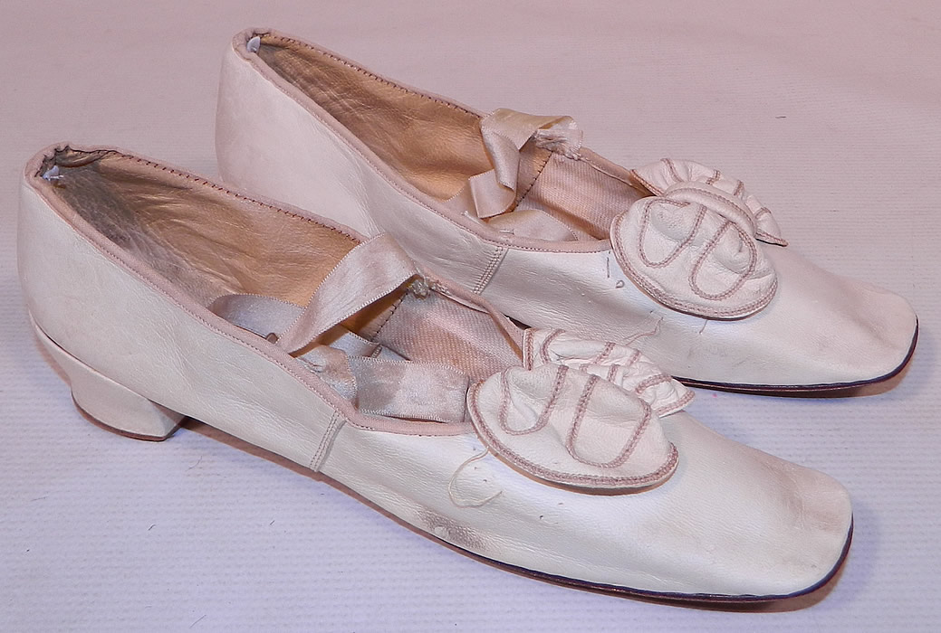 Victorian Wedding White Kid Leather Bow Trim Ribbon Ties Straight Sole Shoes
These beautiful bridal wedding shoes have a slip on slipper style, with squared toes, silk ribbon lacing ties, straight leather bottom soles with no left or right distinction and a low leather covered French Louis XV heel.