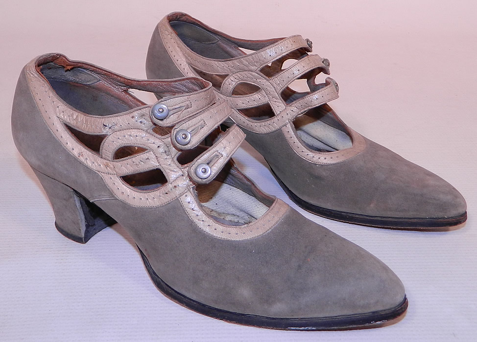 Vintage R.H. White Co. Gray Suede Leather Button Strap Mary Jane Flapper Shoes
This pair of vintage R.H. White Co. gray suede leather button strap Mary Jane flapper shoes date from the 1920s. They are made of a two tone gray color soft suede shoe and decorative punch work leather trim straps. 