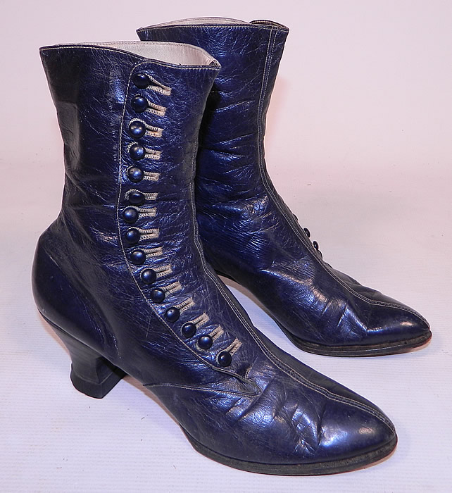 Victorian Women's Navy Blue Leather High Top Button Boots
The boots have pointed toes, 15 navy blue shoe buttons along the side for closure, lined inside in a cream color leather and linen fabric, and have stacked wooden French spool heels. 