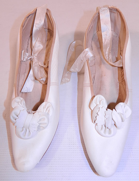Victorian White Kid Leather Bow Trim Silk Ribbon Ties Wedding Shoes
These beautiful bridal wedding shoes have a slip on slipper style, with pointed toes, silk damask ribbon lacing ties, a low leather covered French Louis XV heel and cotton twill lining inside. 