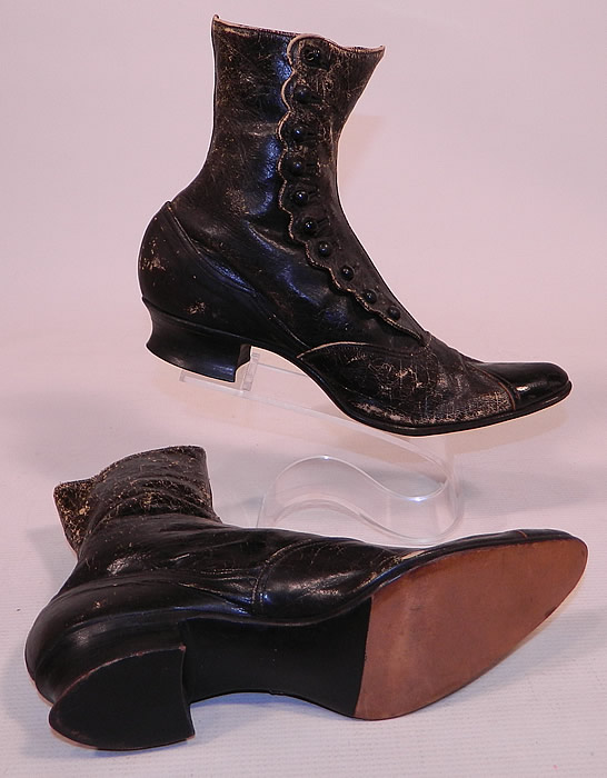 Unworn Victorian Scalloped Side Button Black Leather High Top Boots
The boots measure 7 inches tall, 10 inches long, 2 1/2 inches wide, with 1 inch high heels. They are in unworn condition, but the black leather is worn with flaking, cracking from storage and has not been cleaned, conditioned or polished. 