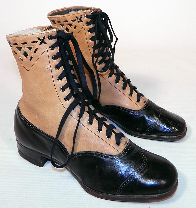 Edwardian Black & Tan Two Tone Leather Lacing Cutouts High Top Boots Shoes
This pair of antique Edwardian era black and tan two tone leather lacing cutouts high top boots shoes date from 1910. They are made of a two tone color combination of a tan leather upper boot and black patent leather lower shoe, with whip stitch lacing decorative cutouts and punch work trim edging.