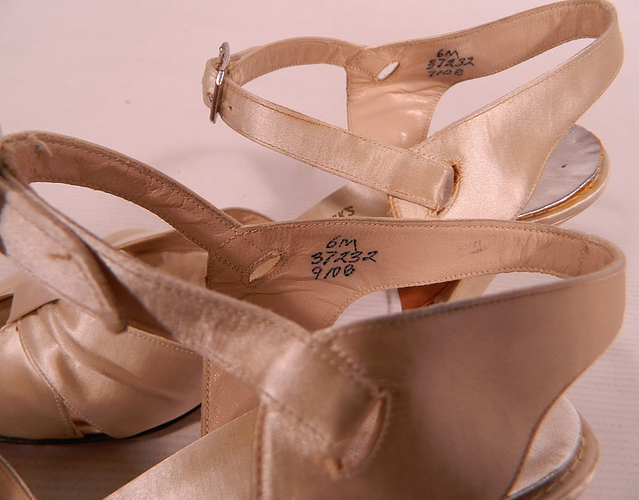 Vintage Bullock's Wilshire White Silk Satin Ankle Strap Evening Bridal Wedding Shoes
The shoes measure 9 1/2 inches long, 3 inches wide, with 3 inch high heels and are stamped inside a size 6 M. They are in good condition and look to have been barely worn. These are truly a wonderful piece of wearable shoe art!