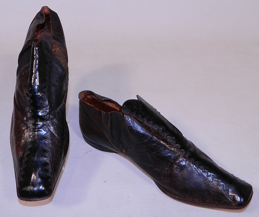 Victorian Brown & Black Leather Crooked Sole Square Toe Dainty Ankle Half Boots
These early dainty half boot shoes have a slightly crooked hard leather bottom sole, squared toes, a low slight heel and ribbed textured fabric gusset insert sides. 
