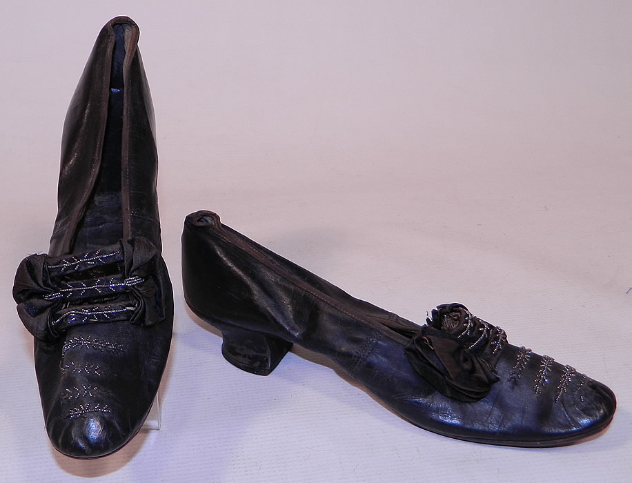 Victorian Black Leather Silk Bow Steel Cut Beaded Louis XV Heel Shoes
These beautiful beaded ball room dancing elegant evening shoes have a slip on slipper style, with a 2 inch high leather covered French Louis XV heel and rounded toes.