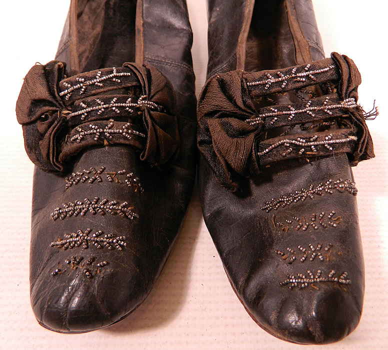 Victorian Black Leather Silk Bow Steel Cut Beaded Louis XV Heel Shoes
They are in good condition and have been gently worn, with some minor wear, slight fraying on the silk bow, a few missing and rusted beads. These are truly a beautiful quality made antique Victoriana shoe which would make for a wonderful display piece!