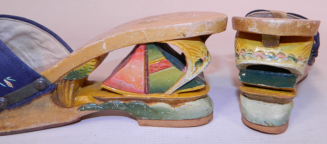 Vintage Philippines Hand Painted Carved Wooden Wedge Sailboat Mules Sandal Shoes
Each &ldquo;souvenir shoe&rdquo; contained a miniature scene inside its wooden heel. The shoes measure 9 inches long, 2 1/2 inches wide and have a 3 inch high heel with added rubber bottom soles. 