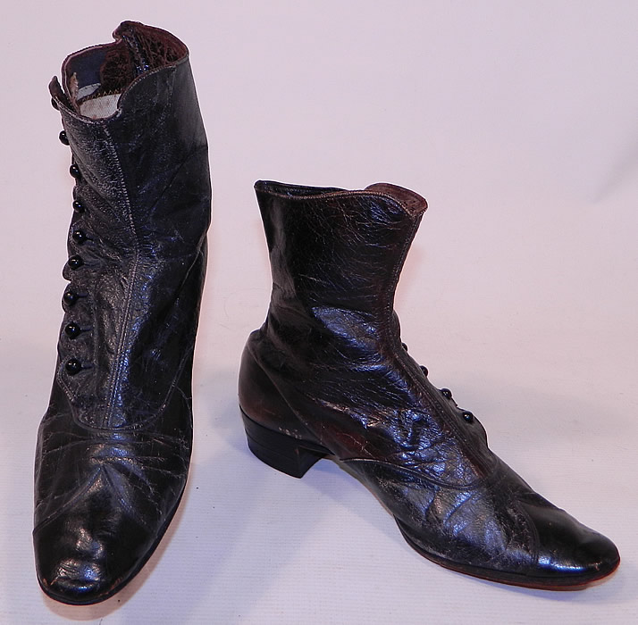 Victorian Antique Scalloped Side Button Black Leather High Top Boots
These women's beautiful boots have pointed slightly squared toes, 9 black shoe buttons along the side for closure and stacked wooden black cube heels. 