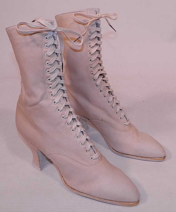 Unworn Victorian Vintage White Cream Canvas High Top Lace-up Boots Shoes
These beautiful boots have slightly pointed toes, the original white shoe string laces for closure and canvas covered French Louis XV spool heels. The boots measure 9 1/2 inches tall, 10 inches long, 2 1/2 inches wide, with 3 inch high heels. These antique boots are difficult to size for today's foot, but my guess would be about a US size 6 or 7 narrow width. 