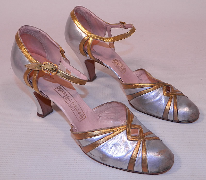 Vintage Marshal Field & Co Aristo Art Deco Silver Gold Leather Ankle Strap Evening Shoes
This pair of vintage Marshall Field & Co Aristo Art Deco silver gold leather ankle strap evening shoes date from the 1920s. They are made of a silver metallic leather, with gold leather trim accents.
