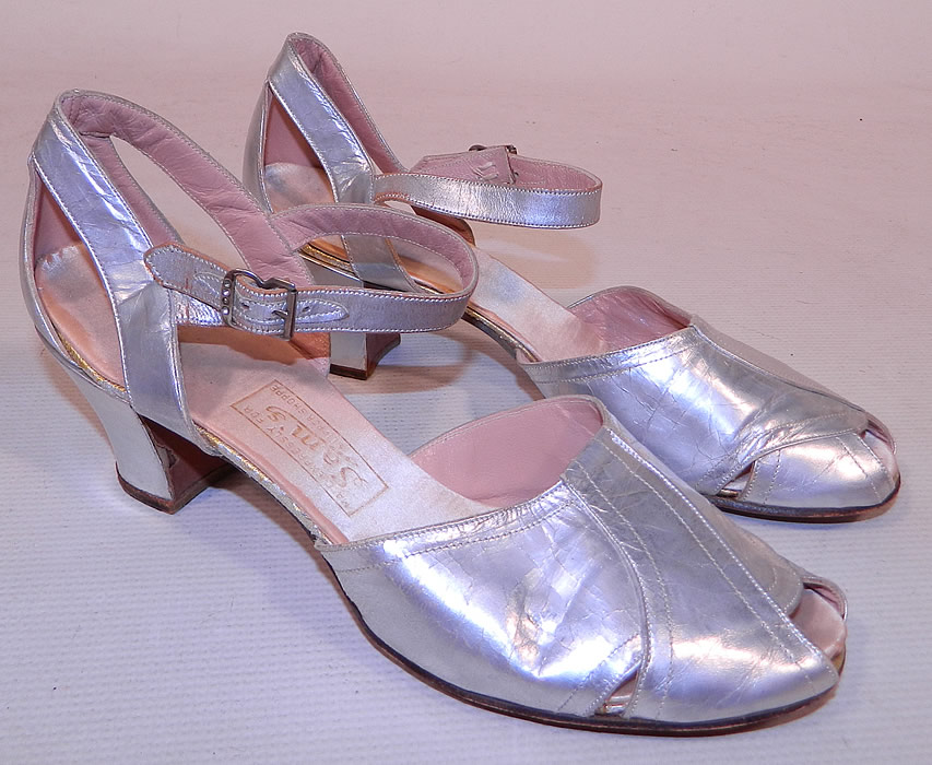 Vintage Sam's Slipper Shoppe Silver Metallic Leather Art Deco Ankle Strap Shoes
These sensational slippers shoes have an open toe, peek-a-boo sides, adjustable buckle closure ankle straps and leather covered cube heels.