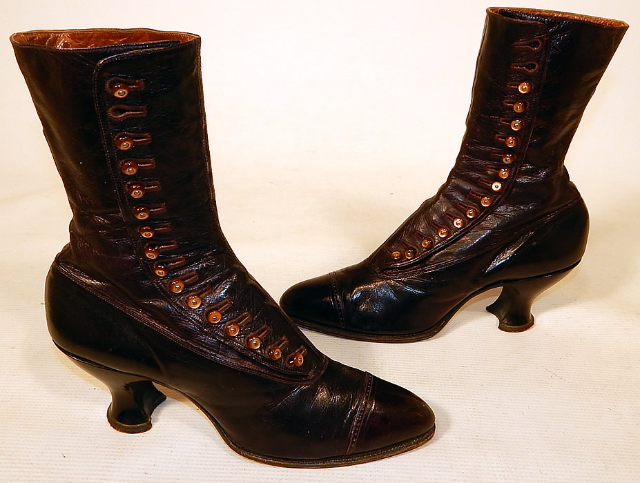 Victorian Women's Antique Bronze Brown Leather High Top Button Boots & Hook
This pair of antique Victorian era bronze brown leather high top button boots and hook dates from 1900. They are made of a supple iridescent bronze brown color leather.