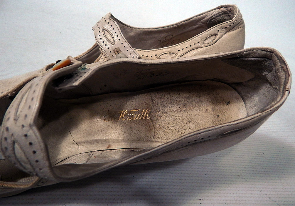 Edwardian Vintage H.H. Tuttle Co. White Leather Button Strap Mary Jane Shoes
They are stamped inside the insole with a "H.H. Tuttle Co." label. The shoes measure 11 inches long, 3 inches wide, with a 3 inch high heel. 