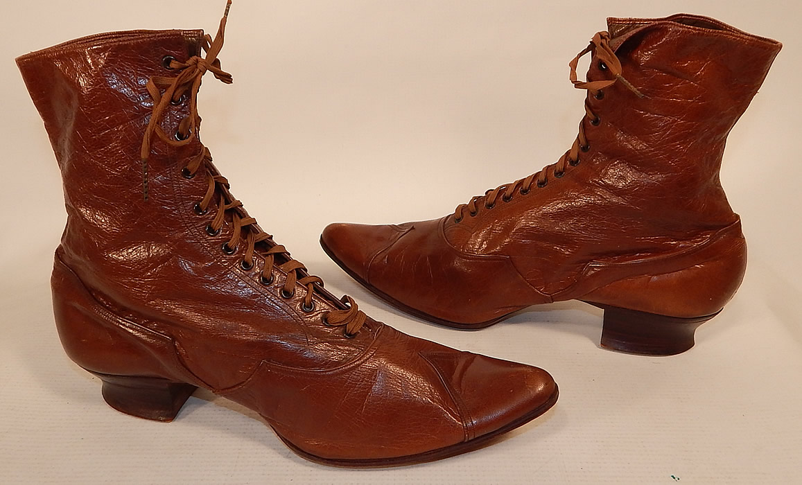 Victorian Antique Womens Brown Leather High Top Lace-up Boots Shoes
 This pair of antique Victorian era womens brown leather high top lace-up boots shoes date from 1880. They are made of a supple brown leather, with decorative cutwork designs along the bottom shoe and on the toes.