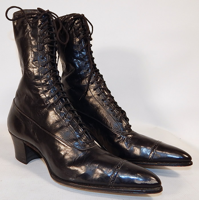 Unworn Victorian Black Leather High Top Lace-up Boots Poehlman Shoe Co.
They are made of a supple black leather, with decorative punch work designs on the toes.