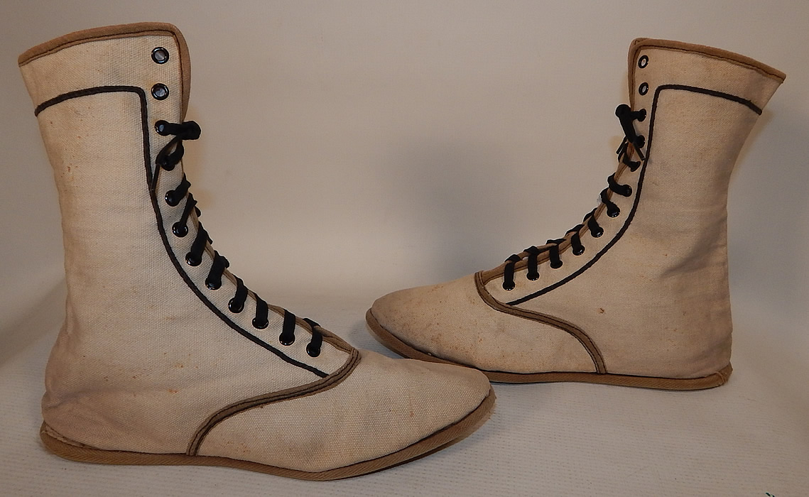 Edwardian Ecru Cream Cotton Canvas Sporting Swim Shoes Bathing Boots
This pair of vintage Edwardian era ladies ecru cream cotton canvas sporting swim shoes bathing boots date from 1910. They are made of an off white cream cotton canvas twill fabric, with an ecru tan color and black trim edging.