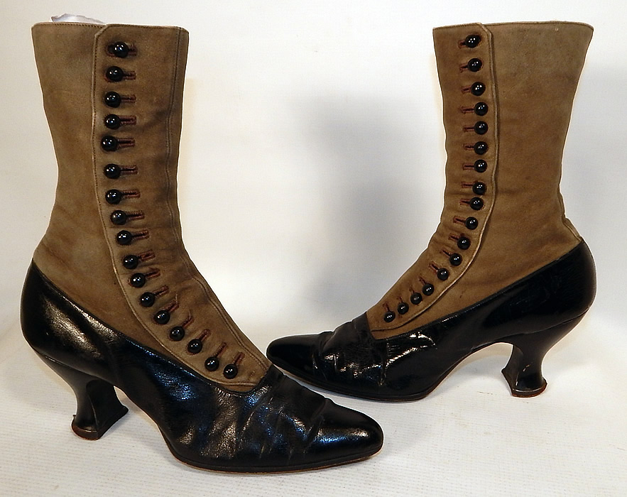 Victorian Women's Antique Gray Suede Black Patent Leather High Top Button Boots
This pair of antique Victorian era women's gray suede black patent leather high top button boots dates from 1890. They are made of a supple grayish brown taupe color soft suede leather upper and black patent leather bottom shoe.