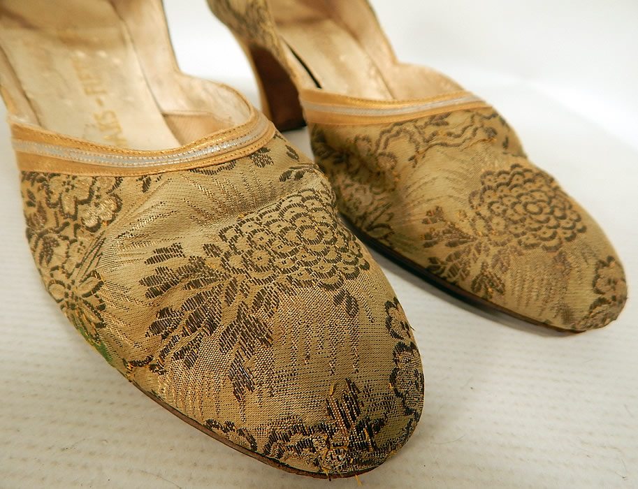 Vintage Saks Fifth Avenue Art Deco Gold Silver Leather Lam&eacute; Lame Brocade Flapper Shoes
These fancy flapper evening shoes have an ankle strap style, with an adjustable yellow rhinestone Art Deco silver buckle closure, rounded toes and gold leather covered French spool heels.