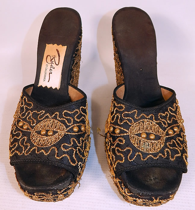 Vintage Ryder of California Black Gold Studded Soutache Wedge Heel Platform Shoes
The shoes measure 9 1/2 inches long, 2 3/4 inches wide, with a 1 inch front platform lift, 4 1/2 inch high heels and are approximately a size 7.
