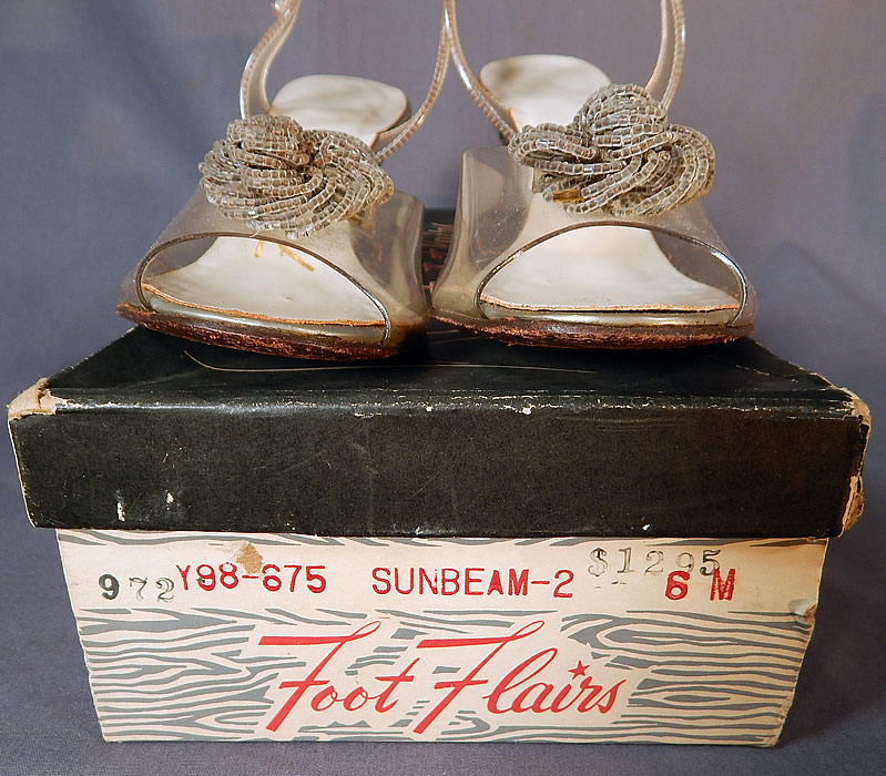 Vintage Foot Flairs Beaded Clear Carved Lucite High Heels Slingback Shoes
The insole lining are stamped in gold lettering "Foot Flairs" size 6 M and come in the original shoe box.