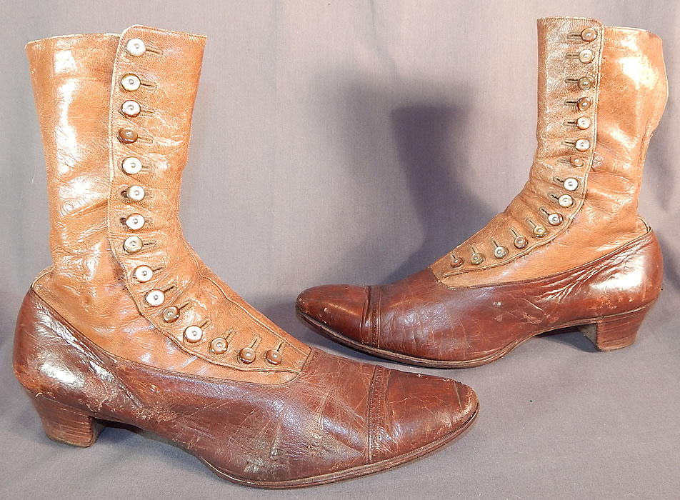 Victorian Antique Brown Two Tone Leather High Top Button Boots Shoes
These beautiful boots have pointed toes, decorative punchwork designs across the toes, the original 15 pearlescent light brown color shoe buttons for closure and stacked wooden cube heels. 