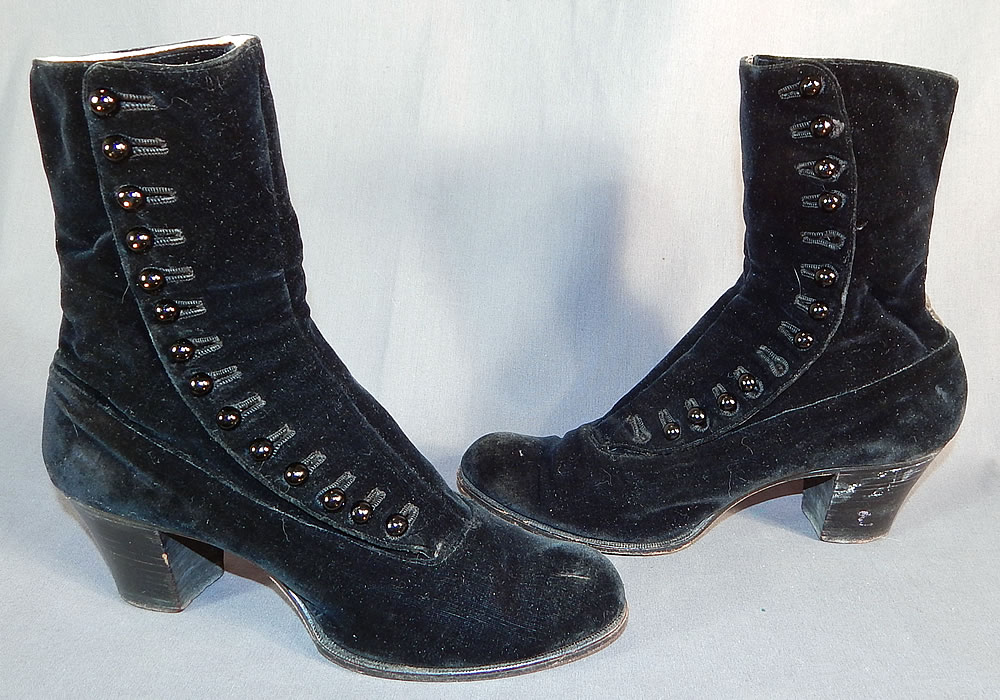Victorian Black Velvet Pink Silk Lined High Top Button Boots Shoes
They are made of a black velvet fabric, with a black leather strip trim on the back. The boots have rounded toes, 14 black shoe buttons along the side for closure, stacked black wooden cube heels, lined in pink silk along the tops and linen lined, stamped inside size 36.