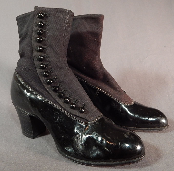 Victorian Unworn Womens Black Wool Patent Leather High Top Button Boots
This pair of antique Victorian era unworn womens black wool and patent leather high top button boots date from 1900. They are made of a black patent leather bottom shoe, with a black wool fabric top. 