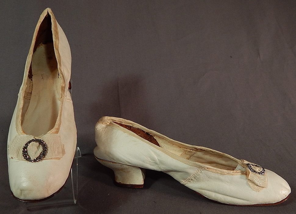 Victorian White Kid Leather Steel Cut Beaded Buckle Silk Bow Wedding Shoes
The shoes measure 9 inches long and 2 1/4 inches wide, with a 1 inch high heel. 